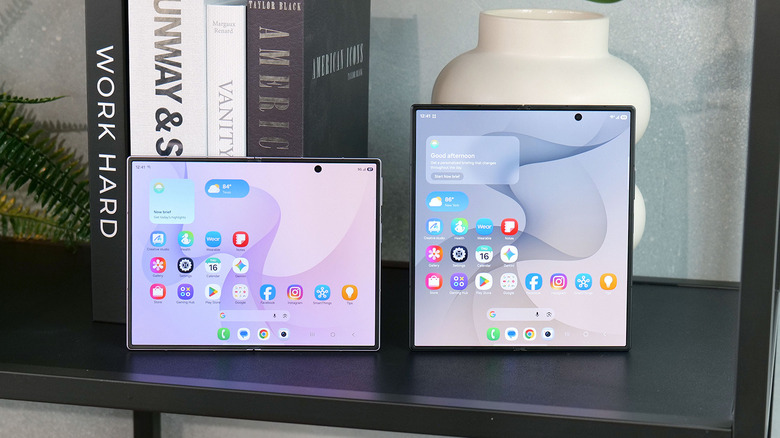 The Samsung Galaxy Z Fold 8 and Z Fold 8 Ultra on a table with books and a vase in the background.