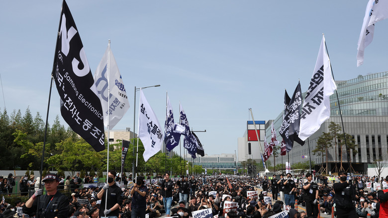 People rallying carrying banners.