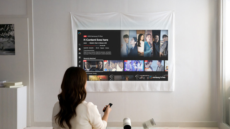 A woman using a Samsung projector.