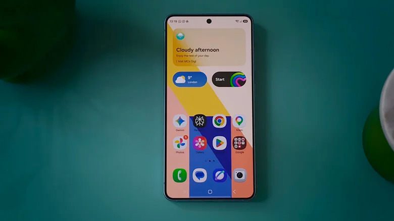 Galaxy S26 phone on a teal surface