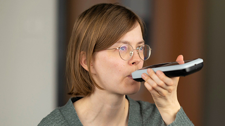 A female blowing into a Nutrion.