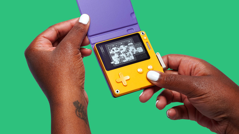 Playdate with a purple cover in someone's hands