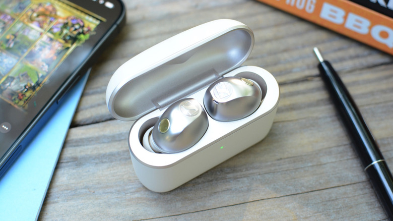 Sennheiser Momentum True Wireless 5 earbuds in the case with the lid open.
