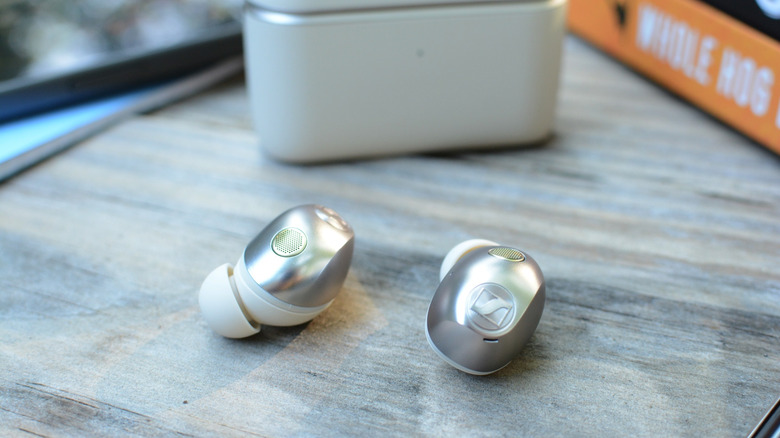 Sennheiser Momentum True Wireless 5 earbuds laying outside of the charging case.