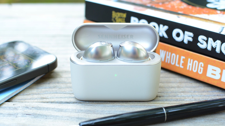 Sennheiser Momentum True Wireless 5 earbuds in the case with the lid open.