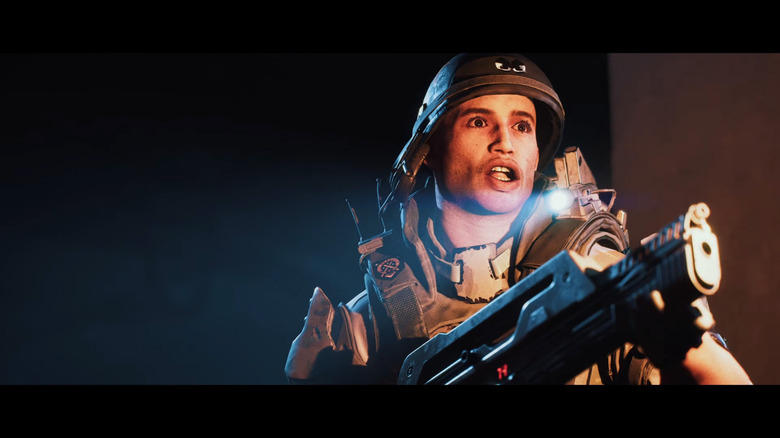 Video game still: a person looking scared as they blast sci-weapons in the dark