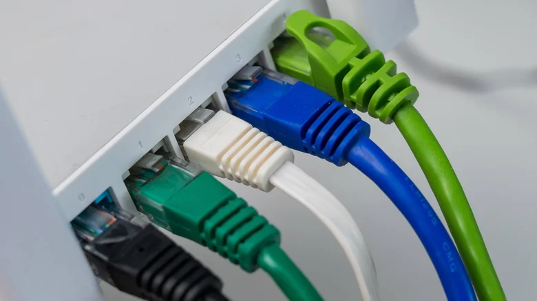 Various Ethernet cables plugged into the back of a device.