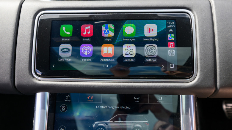 An Apple CarPlay screen with visible reflections.