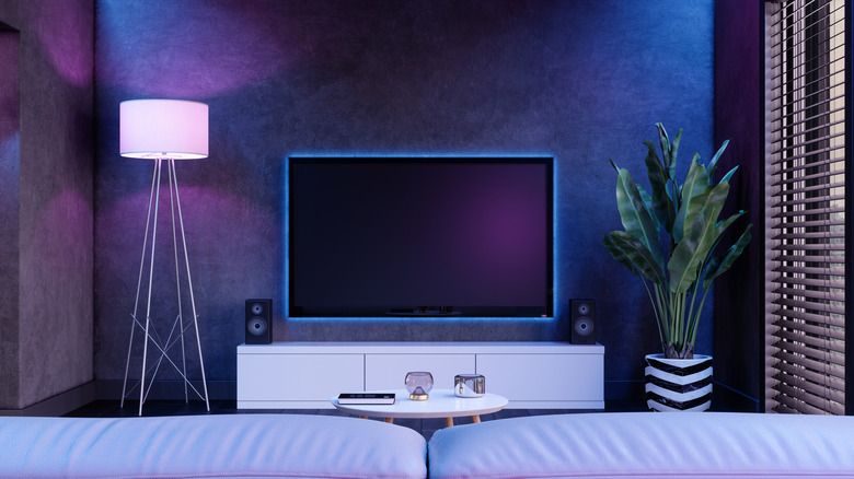 A modern living room and TV with fancy lighting.