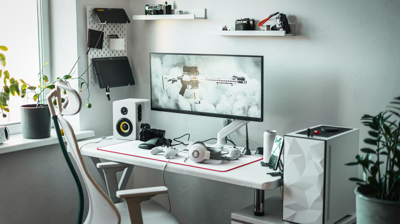A gaming setup with an ultrawide monitor