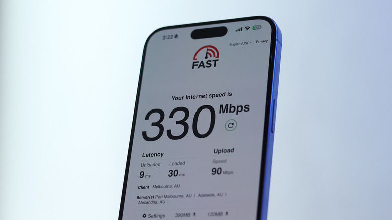 A phone showing speed test results on its screen