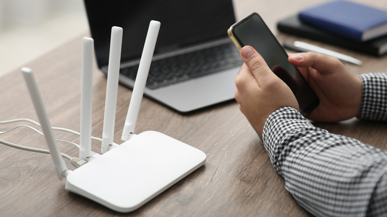 Person configuring a router using a smartphone