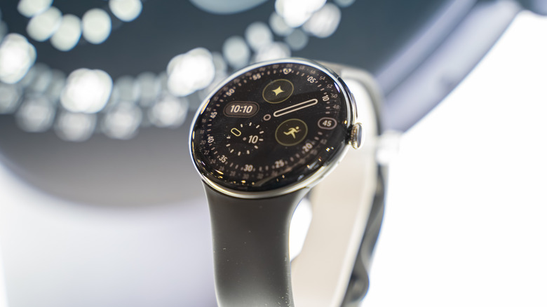 The Google Pixel Watch 4 in front of a display