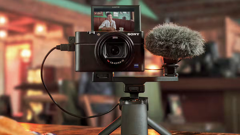Sony's RX100 VII is shown with the screen flipped up and mounted on a small tripod.
