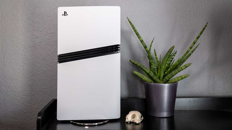 Sony PlayStation 5 Pro sitting beside a plant and a skull for some reason