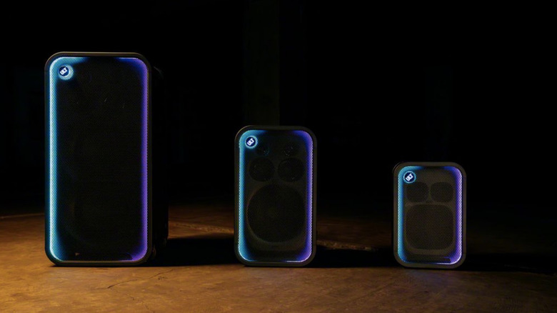 Three speakers standing in a row.