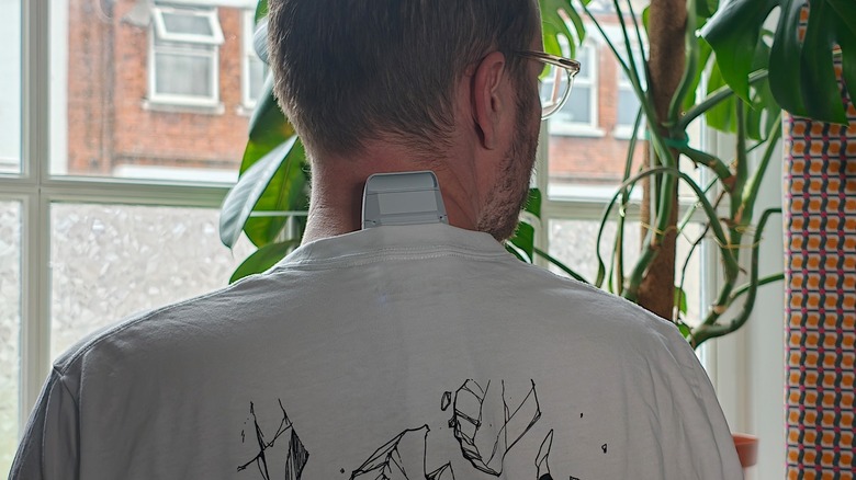 A man wearing Sony's Reon Pocket Pro Plus under a white t-shirt.
