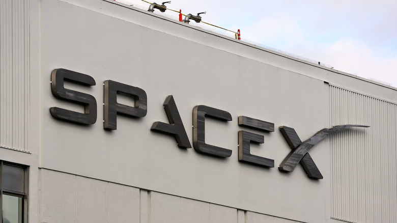 The SpaceX logo as seen on the side of a building.