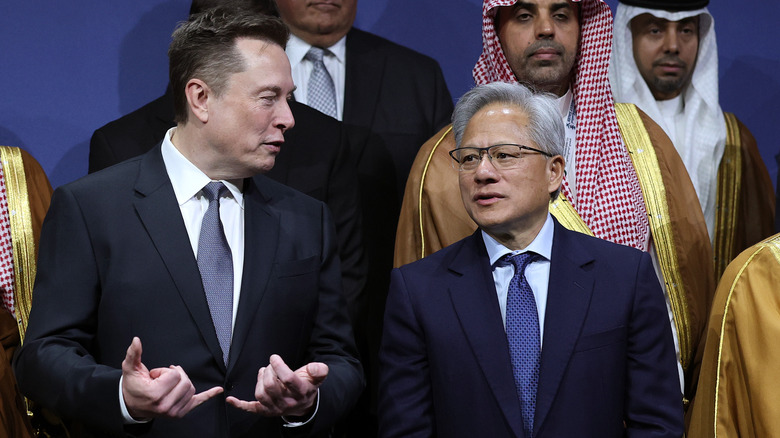 Executives Elon Musk and Jensen Huang speak during a press event.
