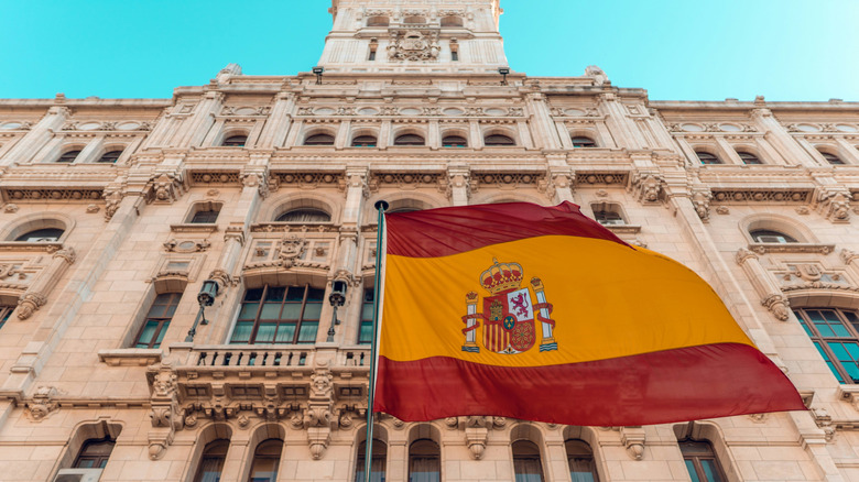 The Spanish flag with a building in the background
