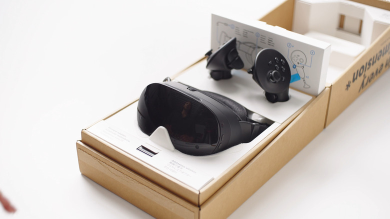 The Steam Frame and controllers in the box (open-faced).