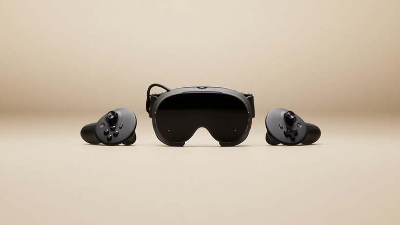 Straight-on shot of the Steam Frame VR headset, with controllers flanking it.