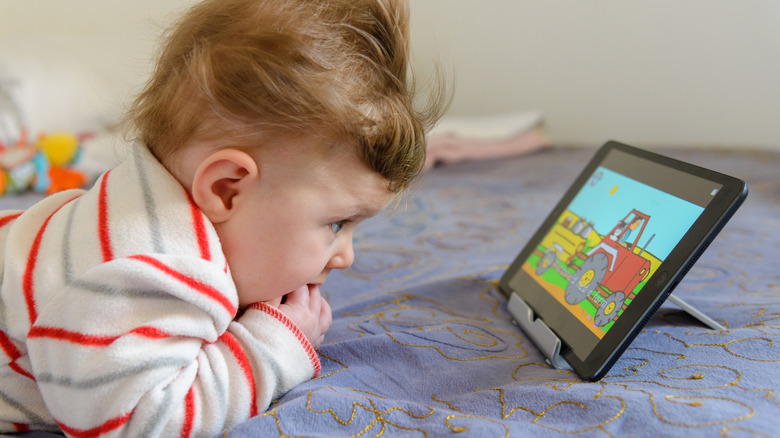 A toddler watching YouTube on an iPad.