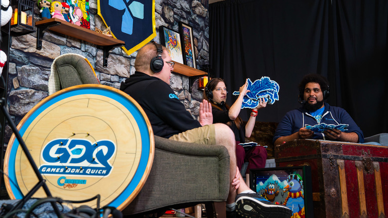 Three Games Done Quick hosts chat on a faux living-room set.