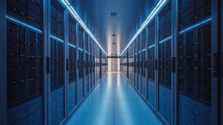 Server racks are shown in a data center in a stock photo