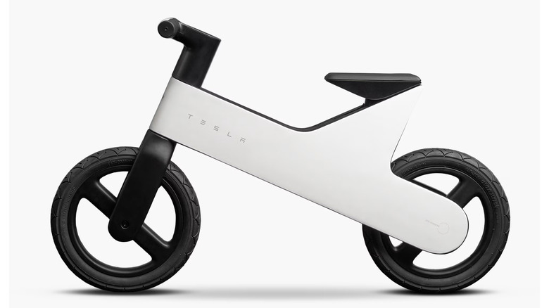 Tesla's balance bike for kids is shown from the side in black and white