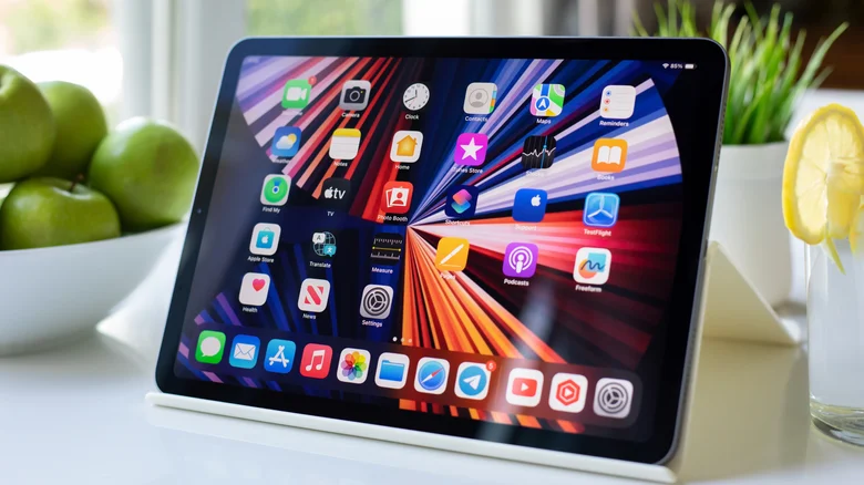 An iPad displaying its homescreen, placed on a kitchen counter