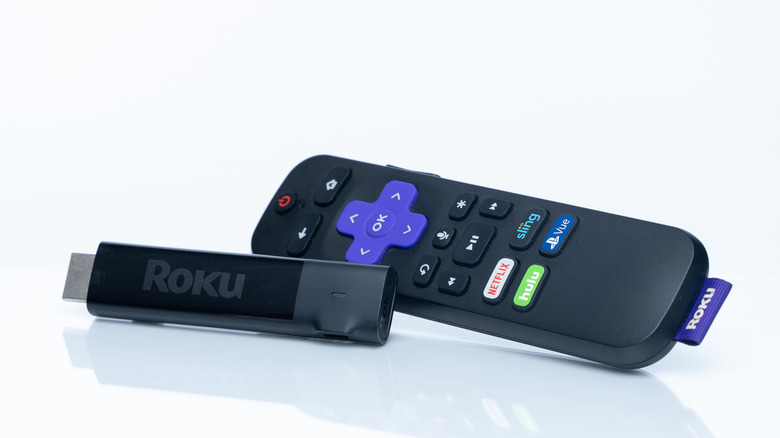 Roku Streaming Stick and remote on white background.