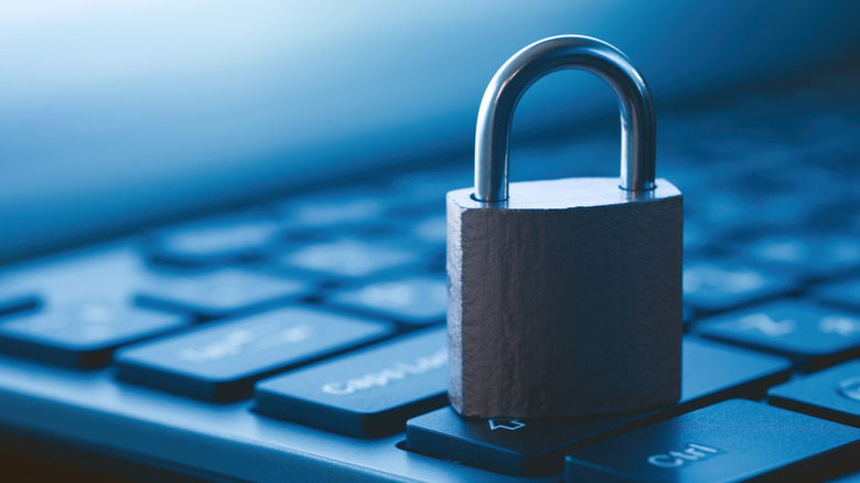 A padlock resting on top of a keyboard.