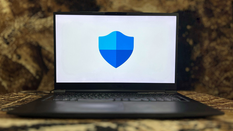 Microsoft Defender shield icon on a laptop.