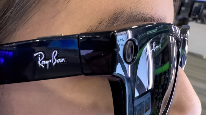 Sideways close-up of Ray-Ban smart glasses on a person's face.