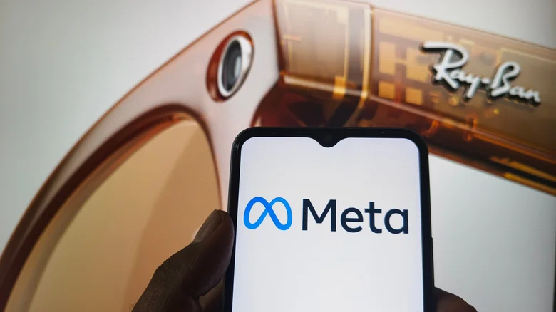 Meta logo displayed on a phone with Ray-Ban Smart Glasses projected in the background.
