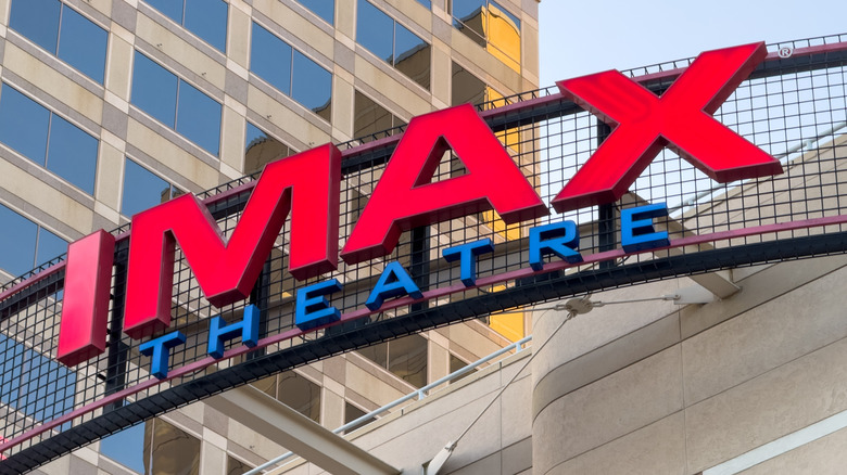 Large red and blue IMAX Theatre sign mounted outside a cinema building.