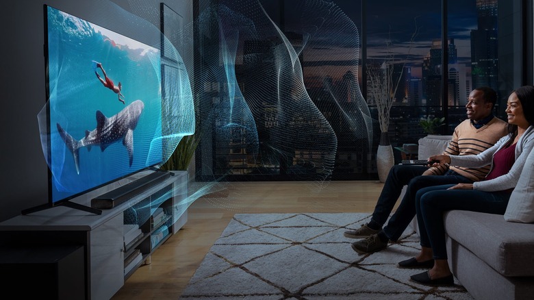 Couple watching TV on couch with immersive sound