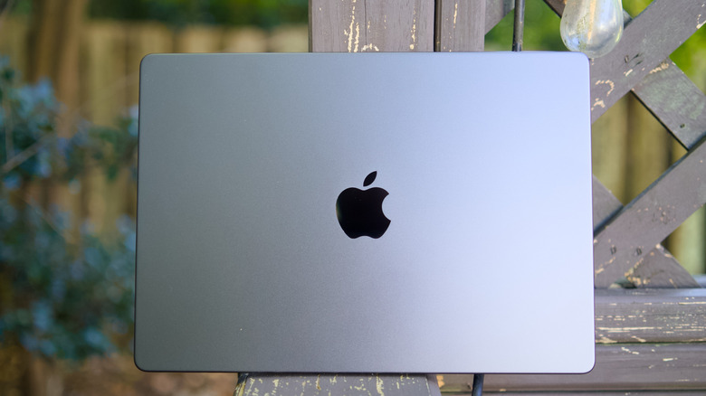 A MacBook Pro on a deck.
