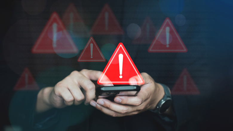 Warning signs overlayed on photo showing a man using a smartphone.