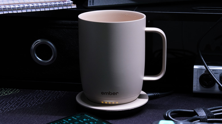 Ember Mug 3 on charging coaster on desk.
