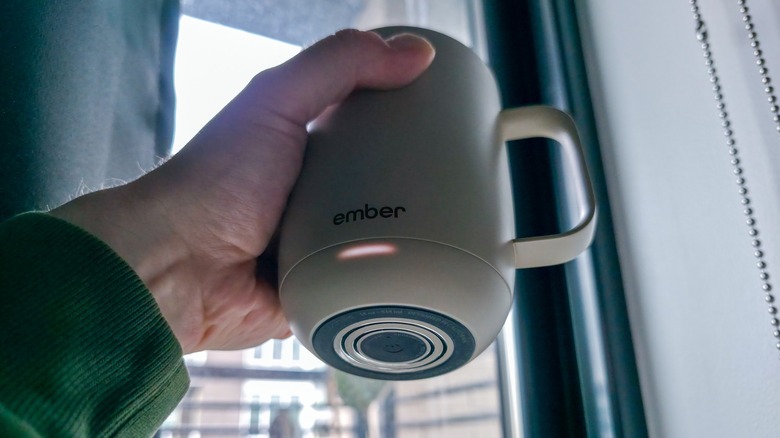 Bottom view of Ember Mug 3 shows power button and charging contact on base.