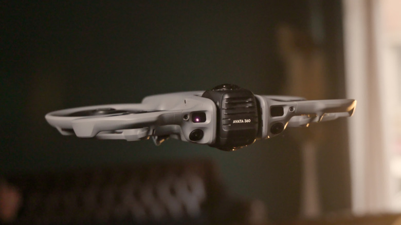 DJI's Avata 360 drone equipped with LiDAR is shown flying in a room.