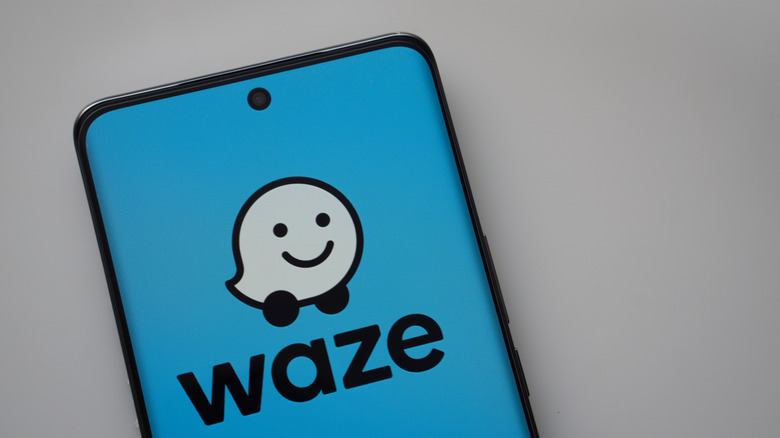 Waze logo on a smartphone.