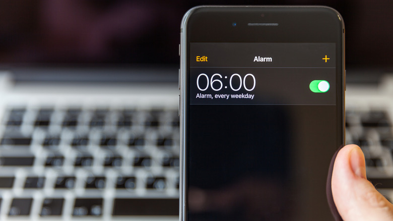 An iPhone screen, displaying an alarm set for 6 AM every weekday.
