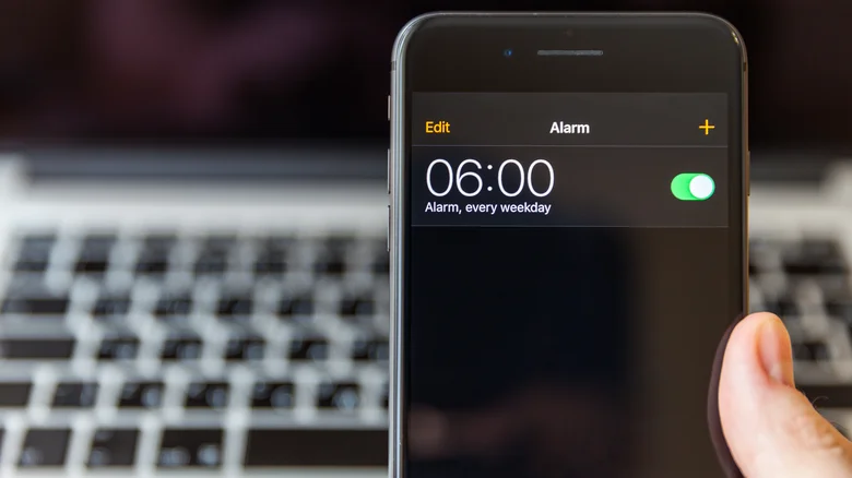 An iPhone screen, displaying an alarm set for 6 AM every weekday.