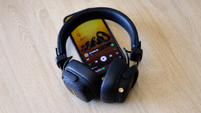 Marshall Milton ANC headphones on top of an iPhone running Spotify.