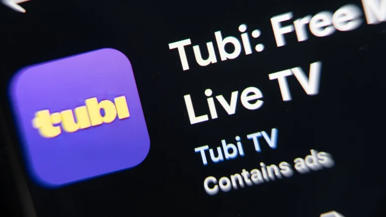 Close-up of the Tubi app on Google Play, showing its purple logo along with "Live TV" and "Contains ads."