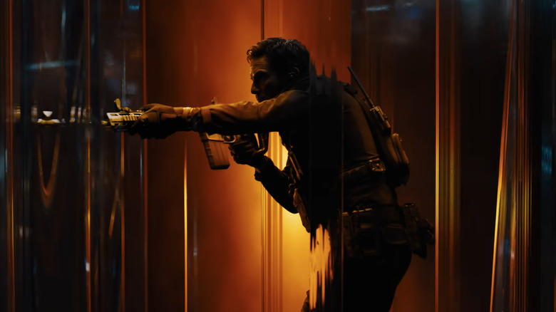 A soldier points a gun.