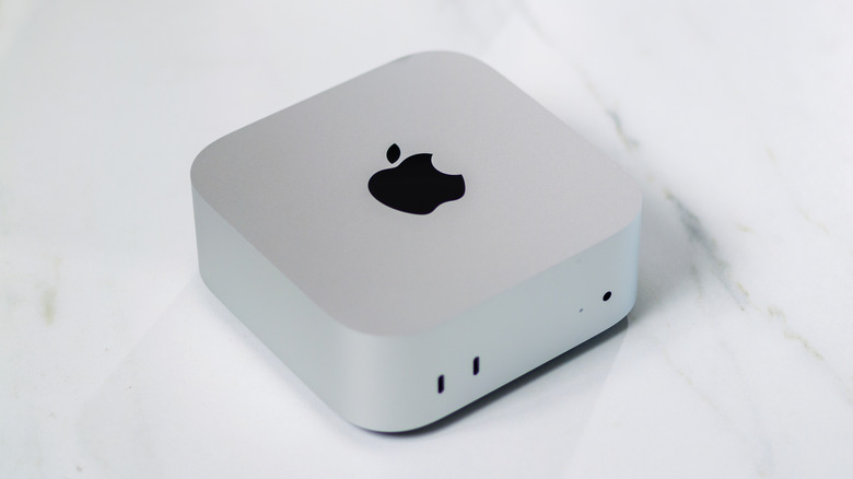 An M4 Mac mini reflecting off a white marble table.